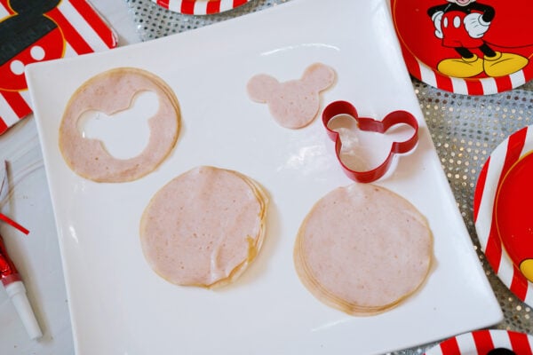Mickey-shaped turkey slices with cookie cutter on plate