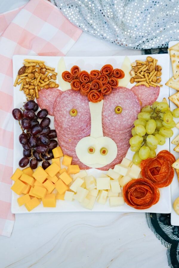 Full highland cow charcuterie board with crackers and fruit