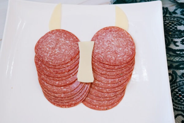 Salami and cheese arranged into a cow face shape