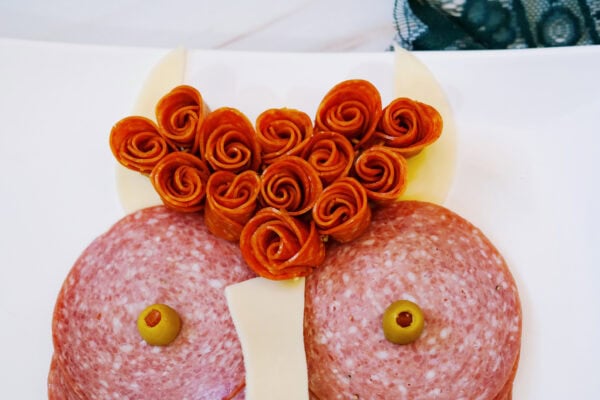 Rolled pepperoni styled as curly highland cow hair