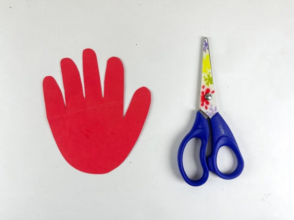 Red handprint cutout and scissors