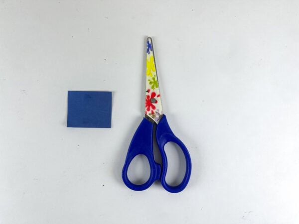 Blue square paper and scissors