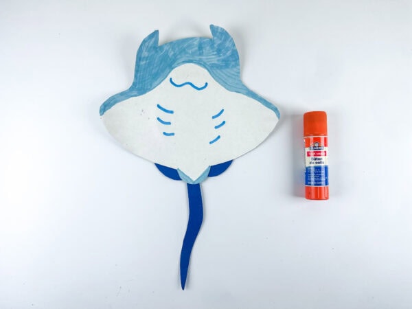 Gluing the stingray paper plate craft together