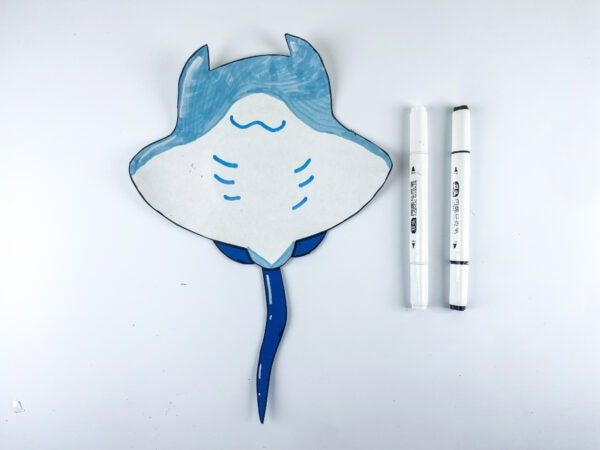 Drawing details on stingray craft with markers