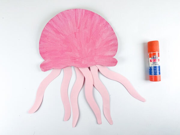 Paper jellyfish with tentacles and glue stick