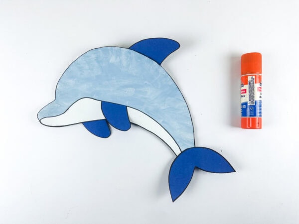 Assembled paper plate dolphin craft with glue stick