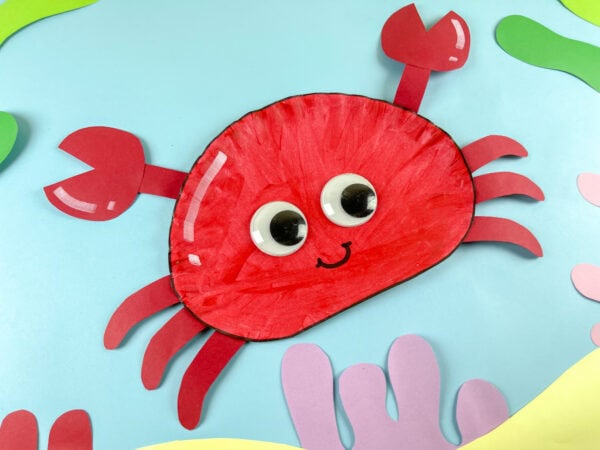 Paper plate crab on ocean themed background