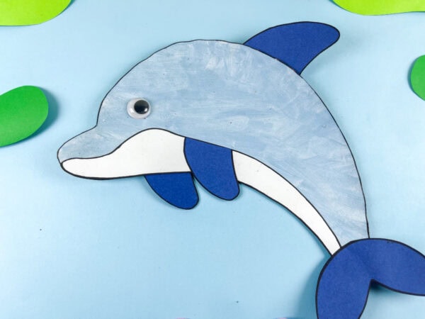 Close up of dolphin paper craft on blue background