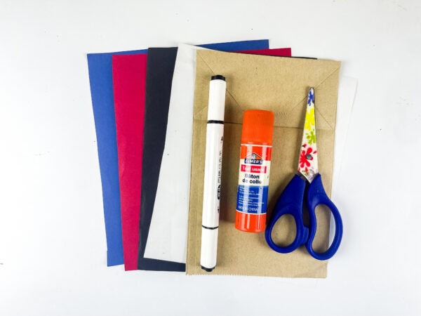 Craft supplies with paper, scissors, glue, and marker