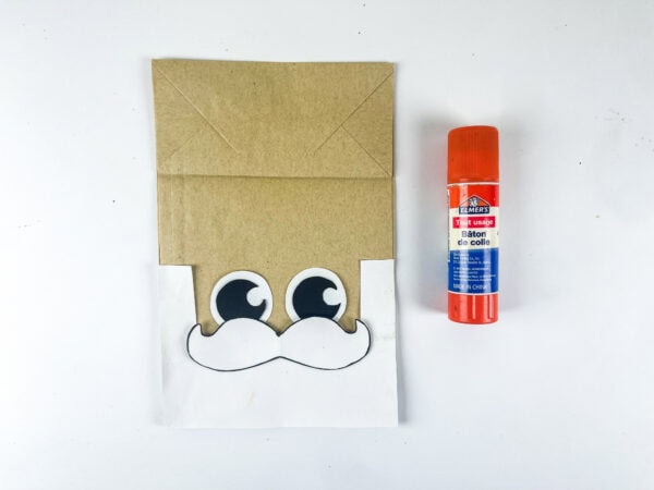 Paper bag with glued eyes and mustache
