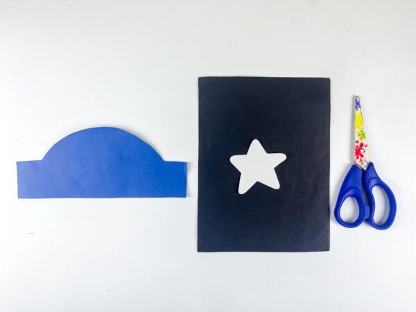 Blue hat cutout with white star and scissors