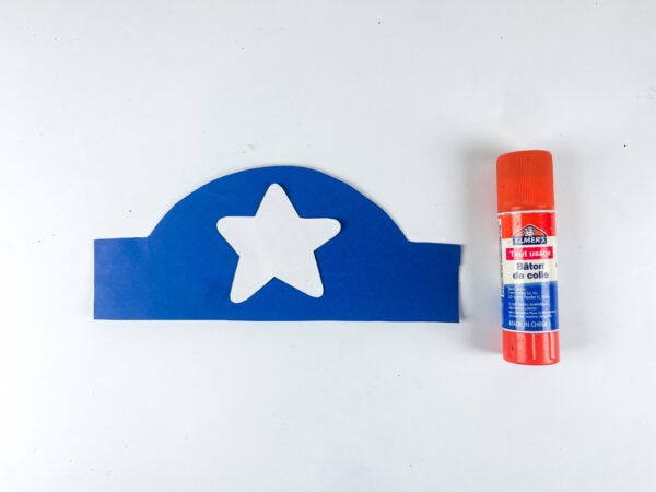 Blue hat cutout with white star and glue stick