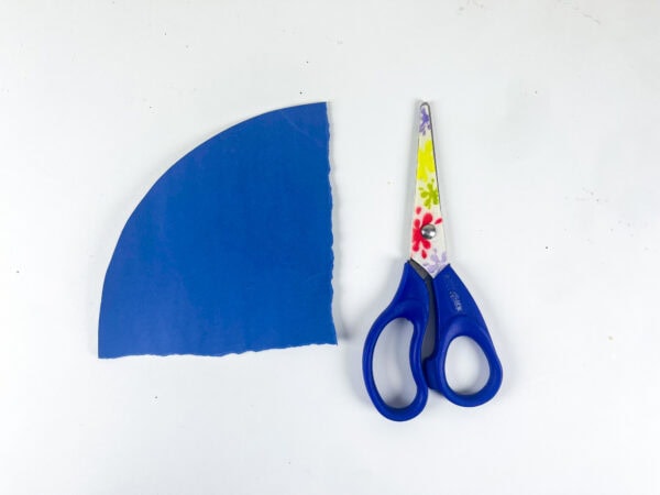 Blue paper flag corner cutout with scissors