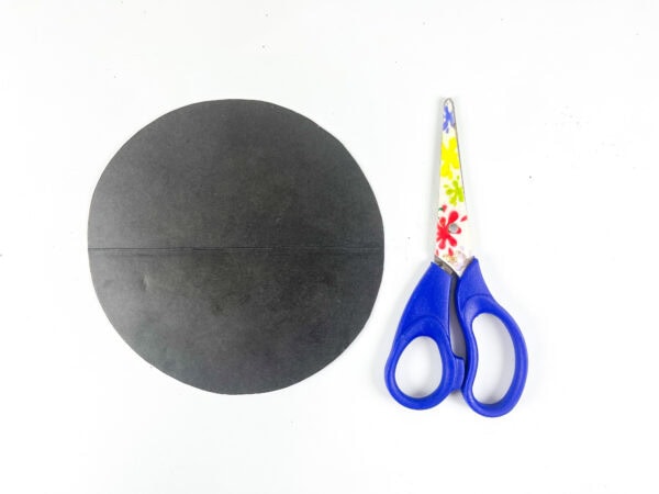 Black paper circle and scissors