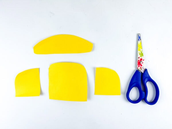 Yellow school bus paper cutouts with scissors