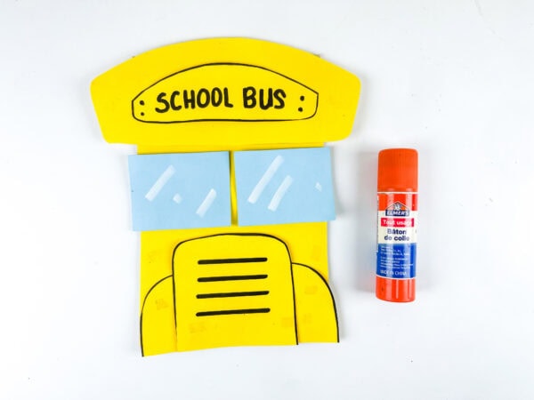 Partially assembled school bus craft with glue stick