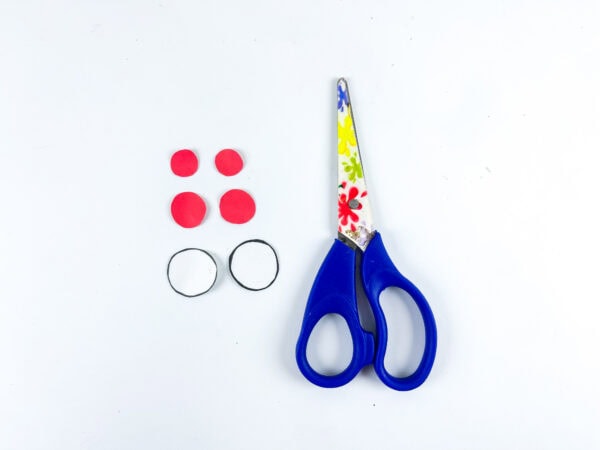 Red circles, white circles, and scissors for craft details