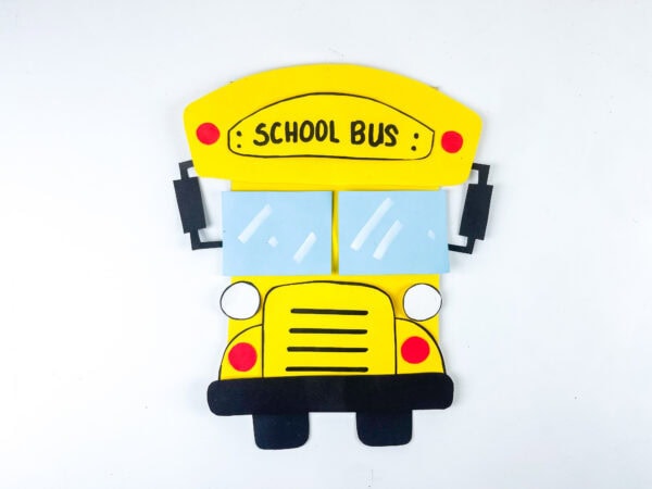 Completed school bus paper craft on white background