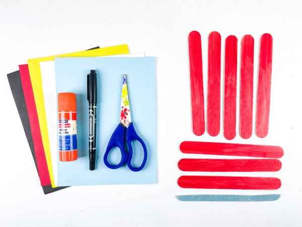 Craft supplies and red popsicle sticks for car craft