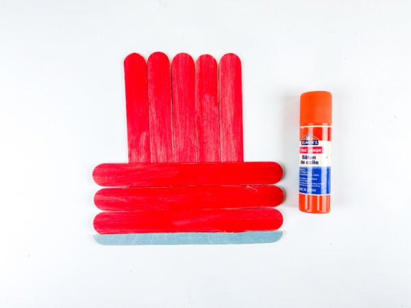 Glued red popsicle stick car base