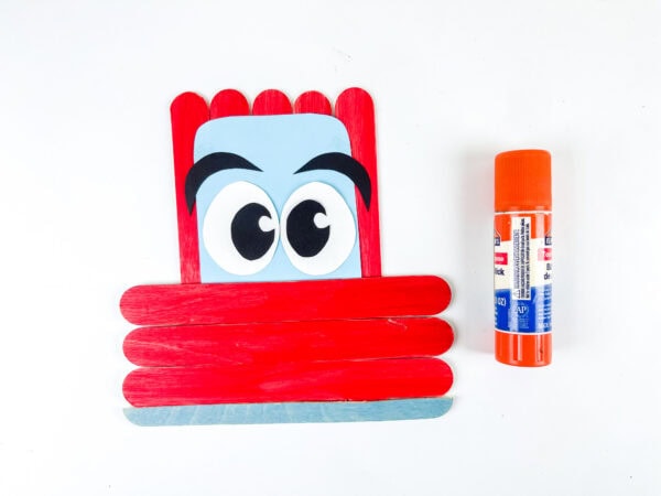 Popsicle stick car with cartoon eyes