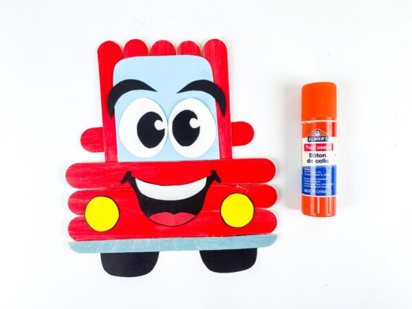 Popsicle stick car with wheels and headlights