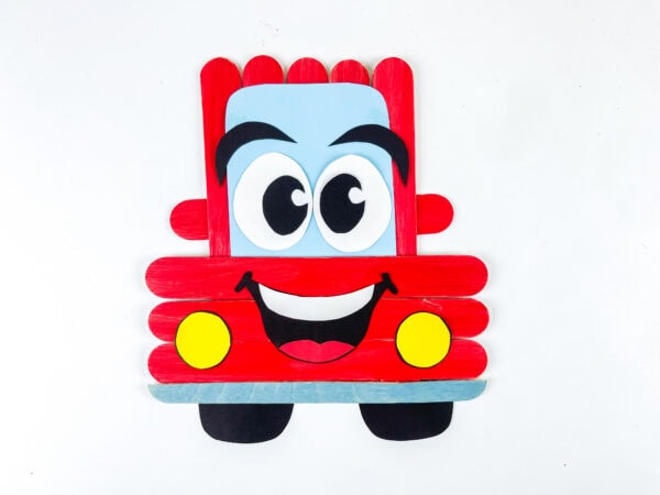 Finished popsicle stick car craft on white background