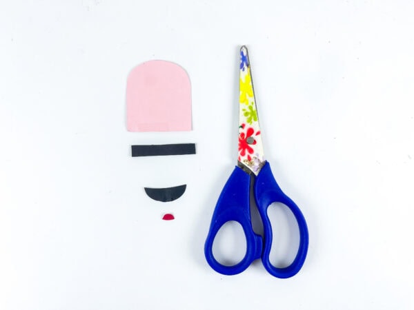 Cut paper pieces for pencil face