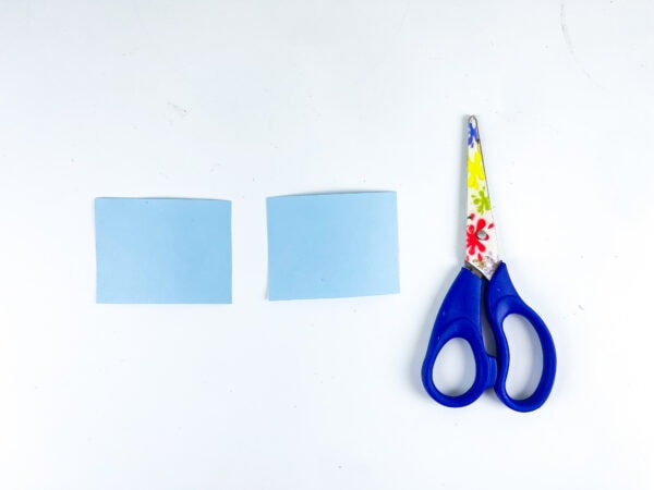 Blue paper windows and scissors for school bus craft