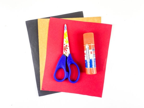 Colored paper, scissors, and glue stick supplies