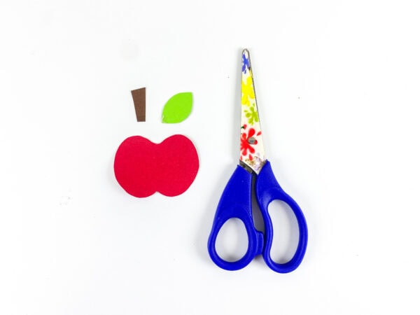 Paper apple pieces with scissors
