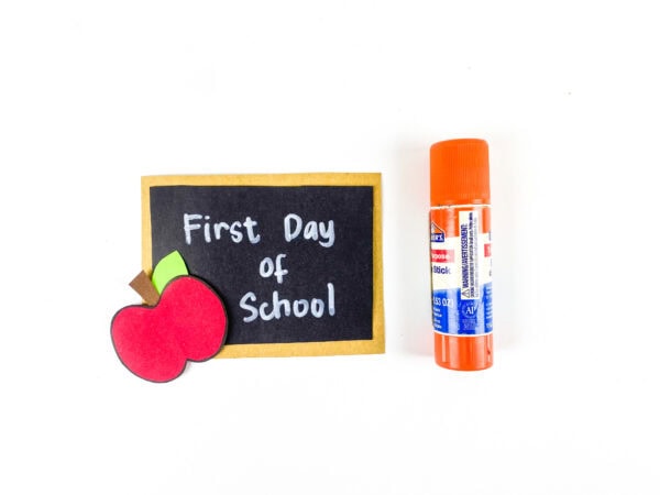 First Day of School sign with apple and glue stick