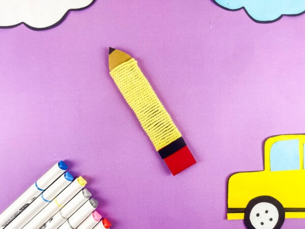 Yarn pencil craft on purple background