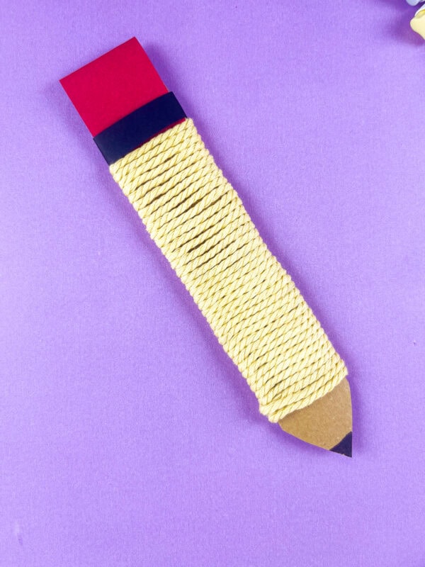Close up of yarn pencil craft on purple background