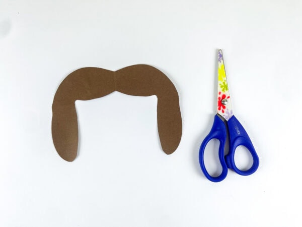 Brown paper hair cutout and scissors