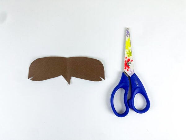 Brown paper hair cutout and scissors