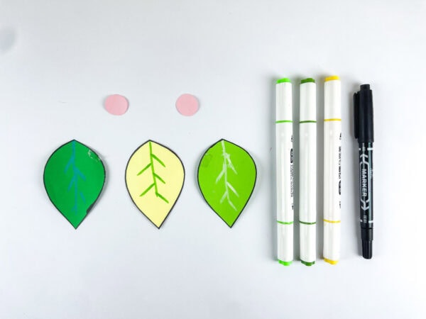 Decorated paper leaves and craft markers