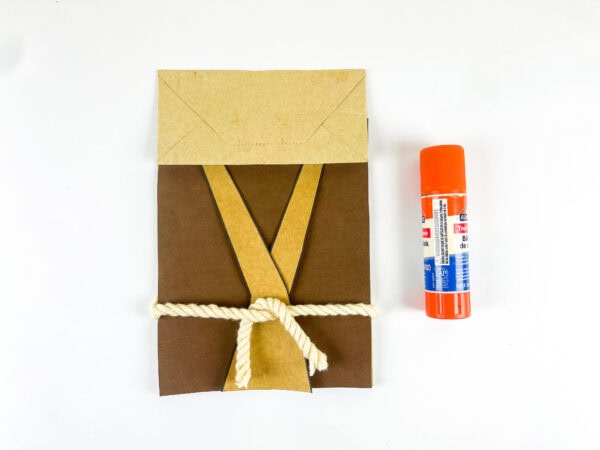Yarn belt attached to Moses paper bag craft