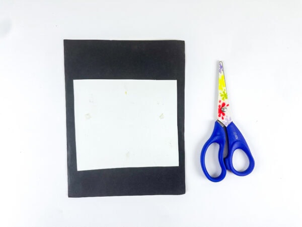 Black paper frame and scissors