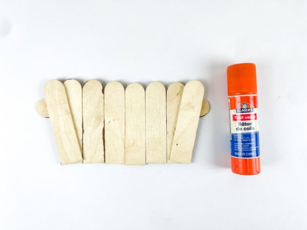 Gluing popsicle sticks into a basket shape