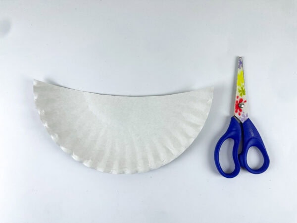 Paper plate cut in half with scissors