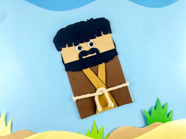Moses paper bag craft on desert scene