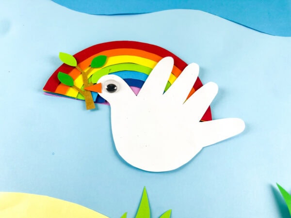 Dove handprint craft on blue background