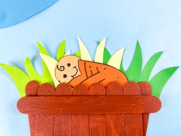 Baby Moses craft with grass background