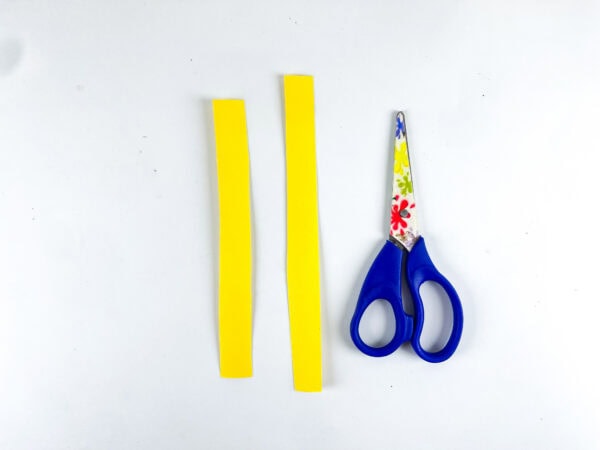 Yellow paper strips and scissors