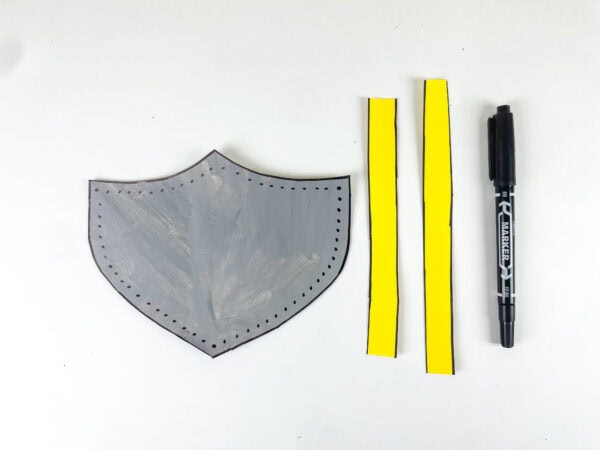 Shield template with paper strips and marker