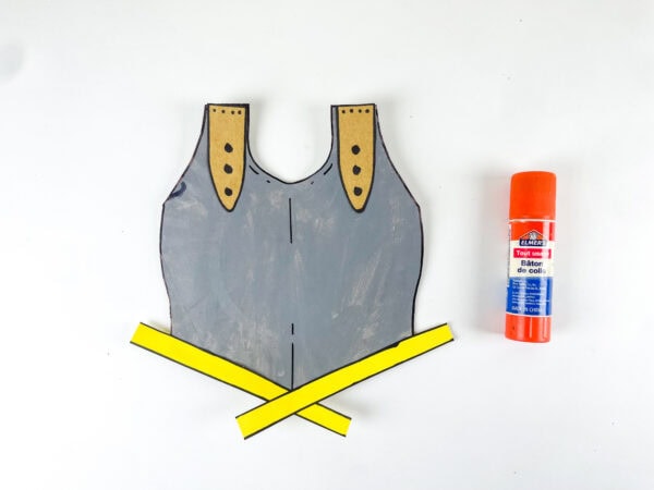 Gluing yellow trim onto breastplate craft