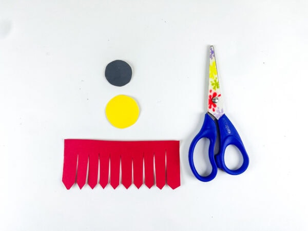 Red belt tassels, belt buckle circles, and scissors