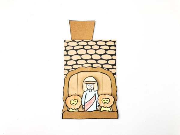 Cave craft with Daniel and lion figures glued inside the den opening.