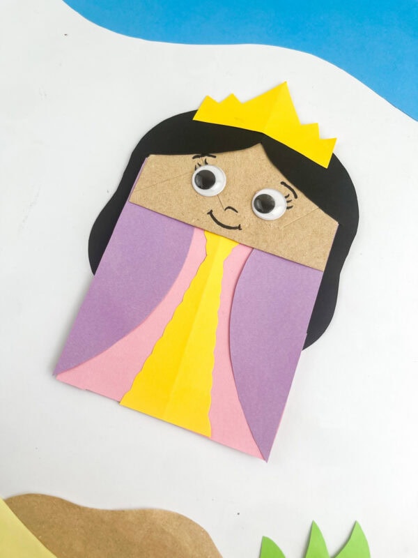 Paper bag craft with hair and dress glued on, before crown and face are added
